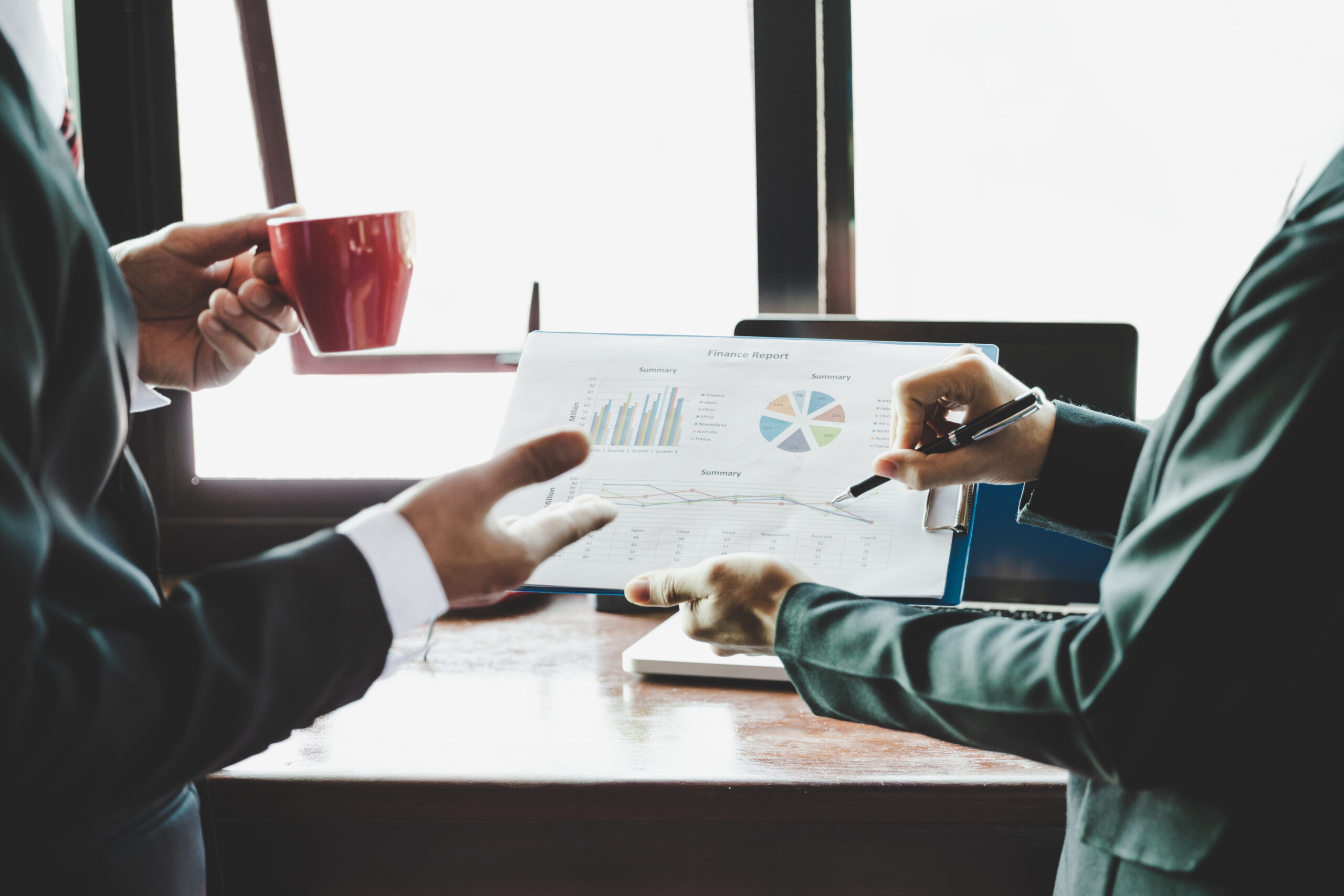 Alt Text Business professionals collaborating in a modern office while reviewing marketing analytics, customer insights, campaign performance metrics, and business growth data on a large digital dashboard.